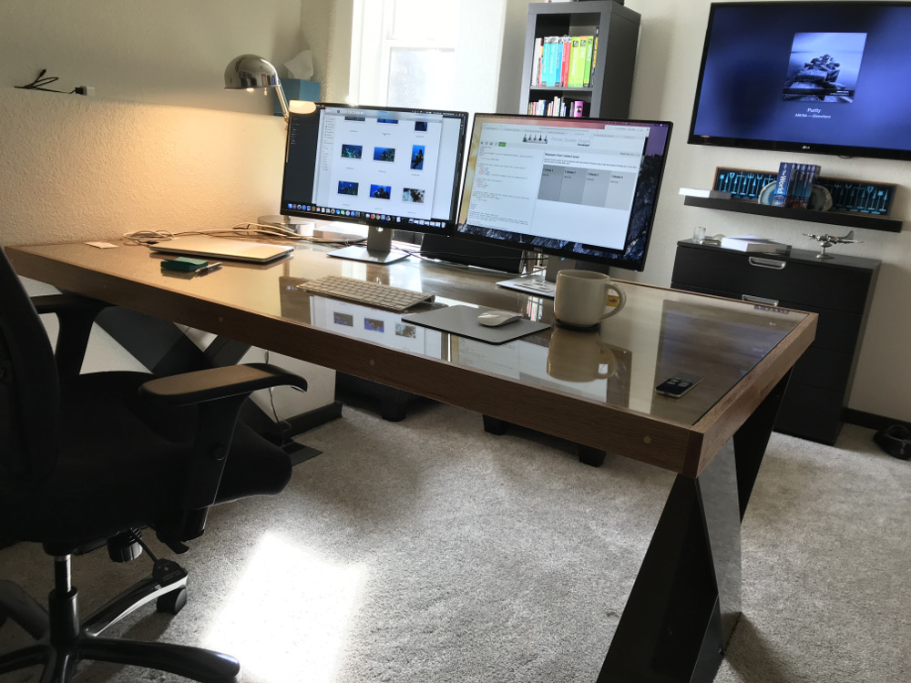 I like making things.  This desk was a project brought on by my disgust of flimsy desks.  I made the top from wood products from the local Lowe's store, put glass on top, and had the metal legs fabricated at a local machine shop from a drawing I made.  This table weighs approximately 10,127 pounds and is not flimsy.